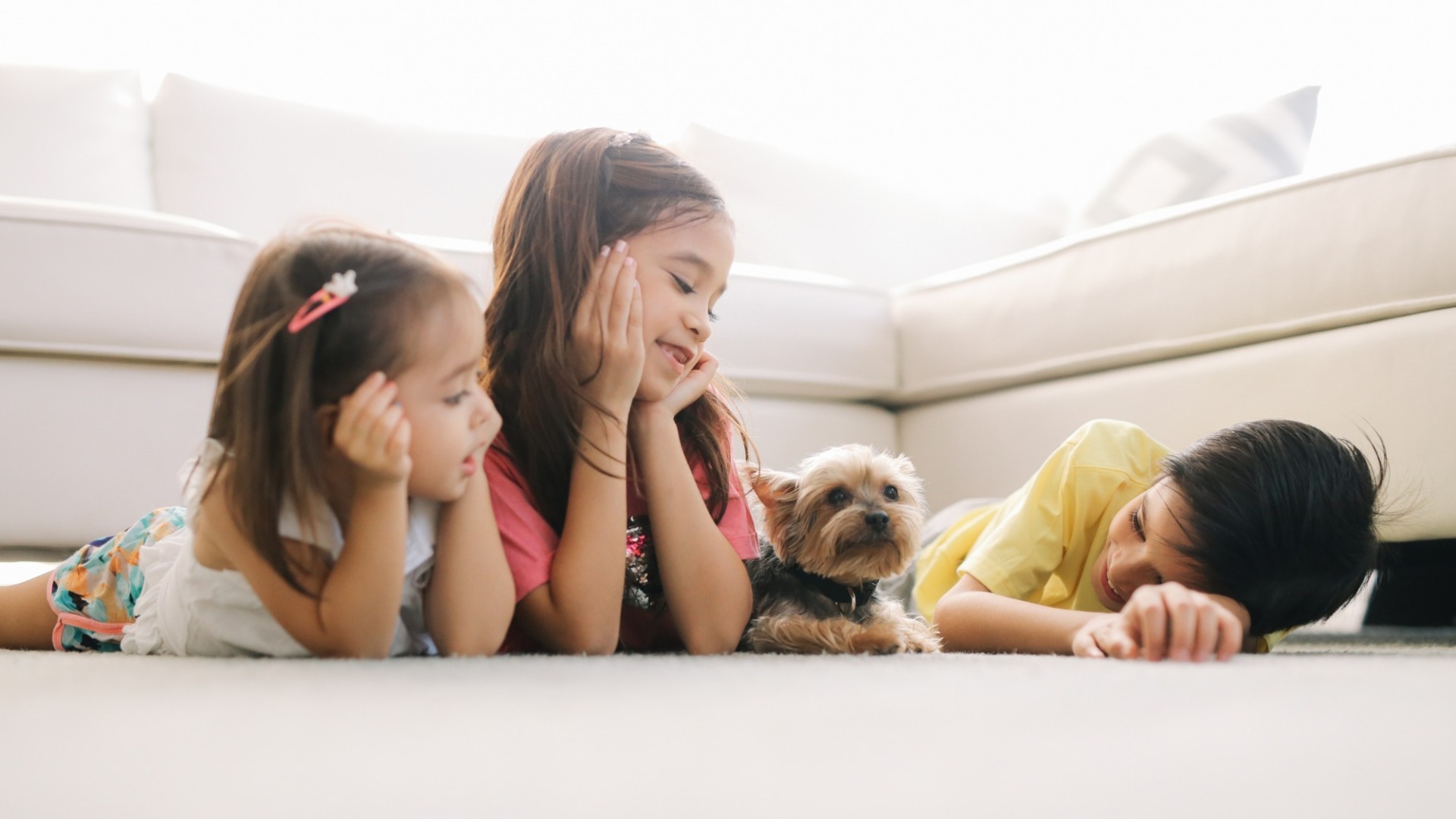 Trei copii alături de un cățel