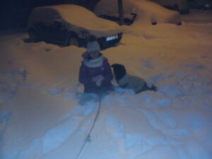 Un câine și un copil în zăpadă