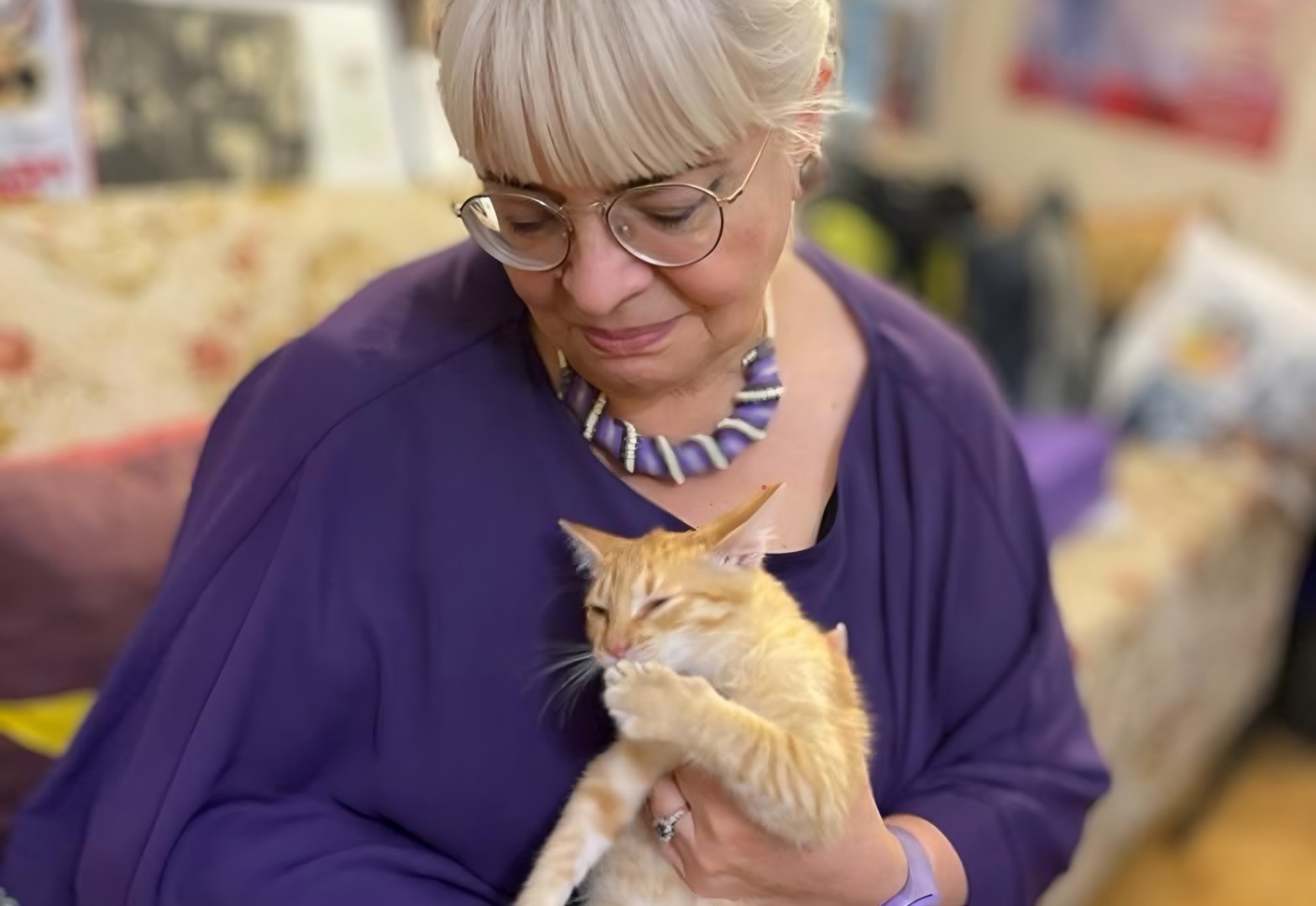 Margareta Nistor ține în brațe o pisică portocalie