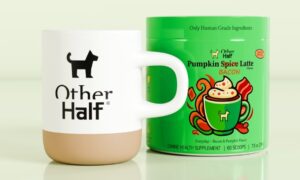 O cană pe care este inscripționat un câine și textul Other half, alături de un recipient cu latte pentru câini