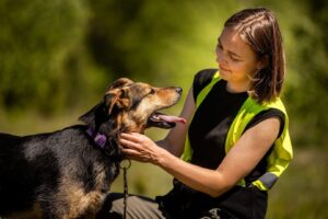 Voluntara unui adăpost de animale mângâie un câine